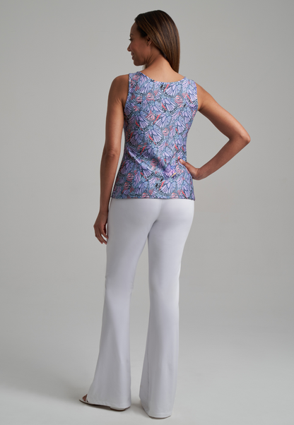 Woman wearing butterfly stretch knit butterfly printed tank top and stretch knit white pants by Ala von Auersperg for spring summer 2021