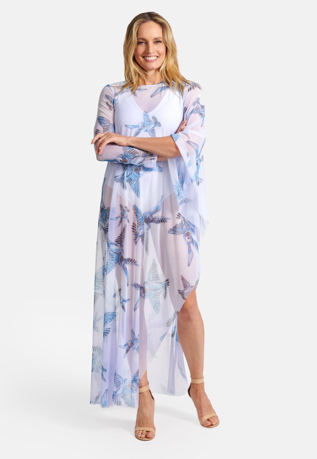 Model wearing mesh one sleeve lavender poncho with blue birds printed on it
