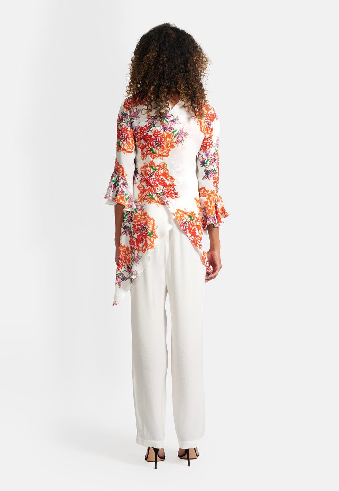 Model wearing asymmetrical silk three quarter sleeve orange and white printed silk blouse top