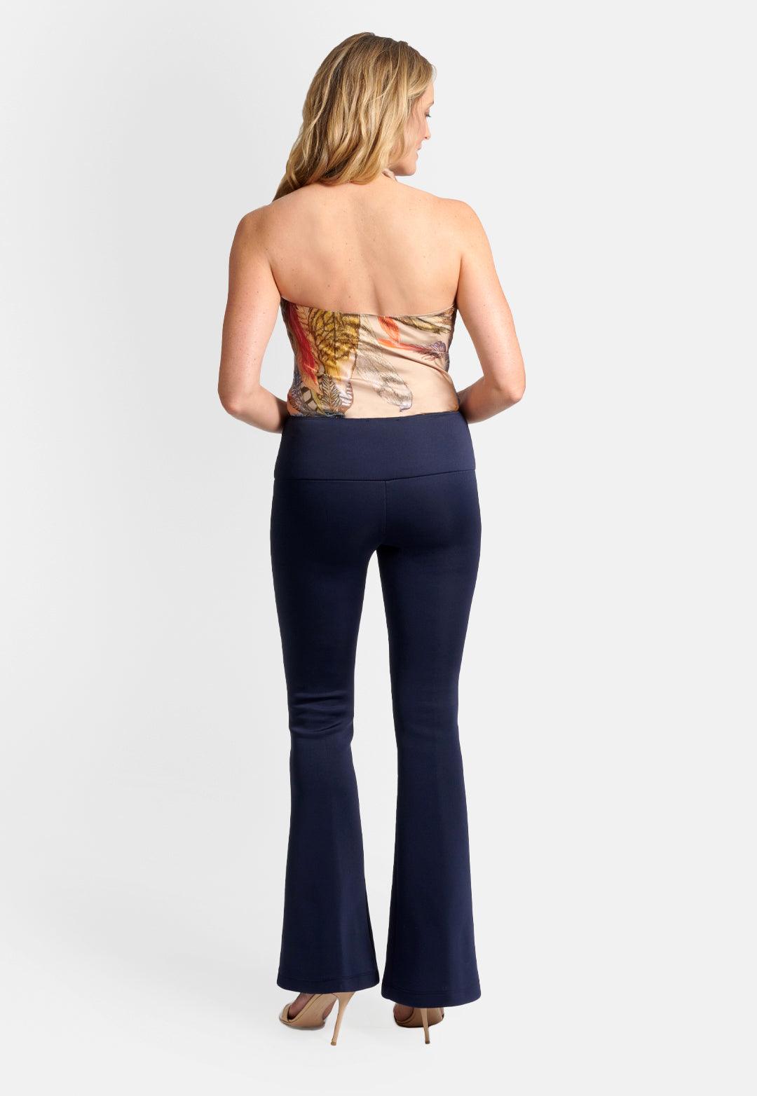 Model wearing silk beige feather printed halter top blouse and navy stretch knit pants