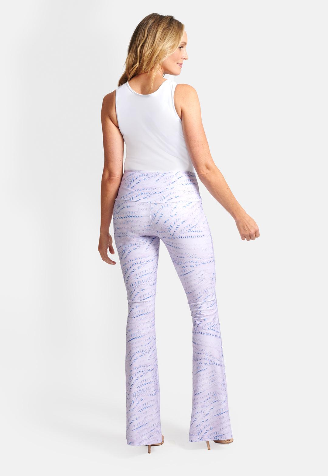 Woman wearing lavender sand track printed stretch knit pants and white stretch knit v neck tank top by Ala von Auersperg