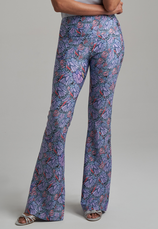 Woman wearing butterfly printed stretch knit purple pants by Ala von Auersperg for spring summer 2021