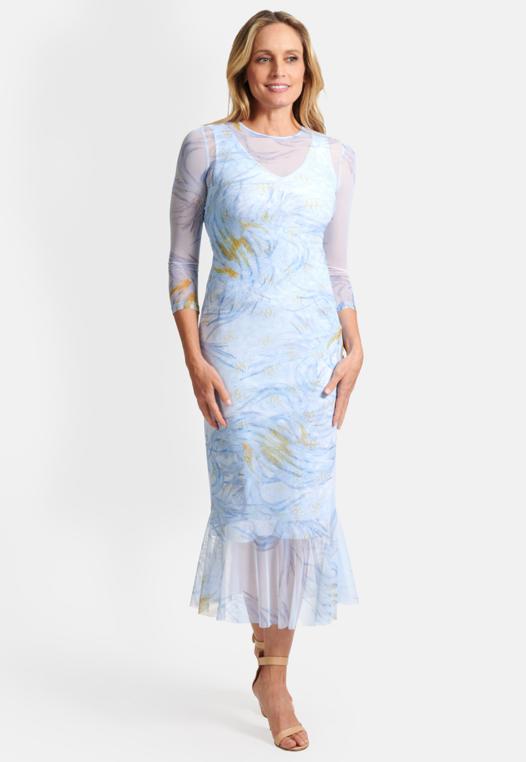 Woman wearing short stretch knit v neck blue and yellow feather printed dress with mesh feather printed dress over it by Ala von Auersperg