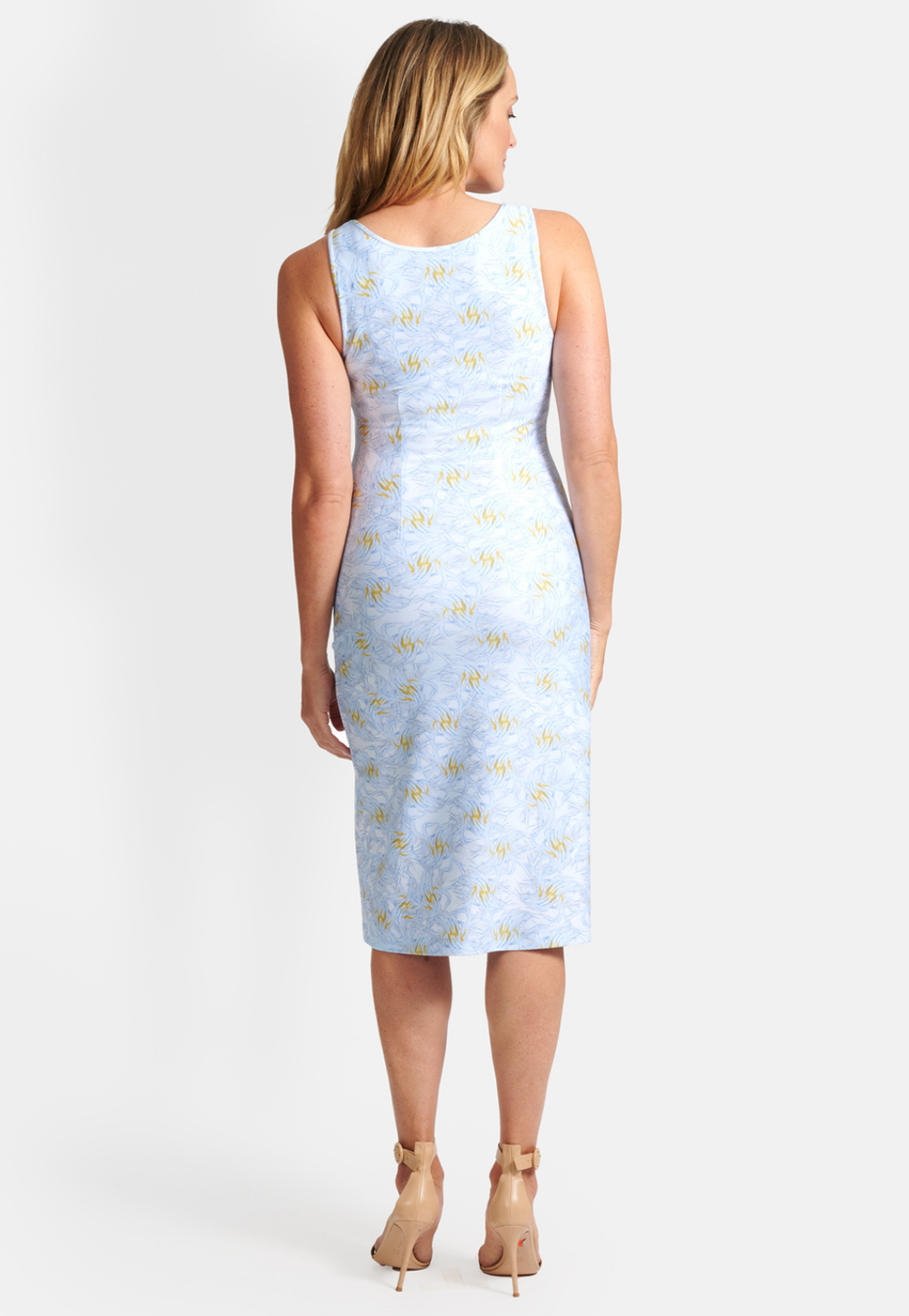 Woman wearing short stretch knit v neck blue and yellow feather printed dress by Ala von Auersperg