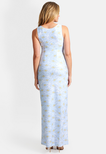 Woman wearing blue and yellow feather printed stretch knit long dress by Ala von Auersperg