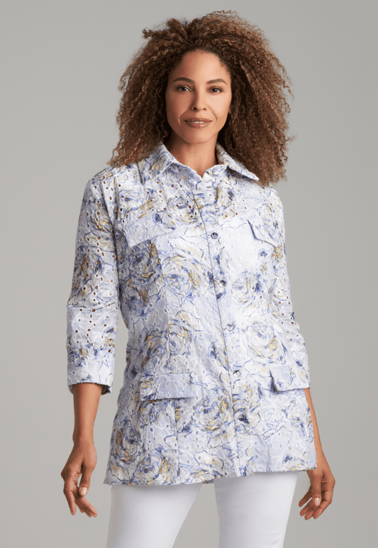 Woman wearing blue rose printed cotton eyelet safari shirt jacket with white stretch knit pants by Ala von Auersperg for spring summer 2022