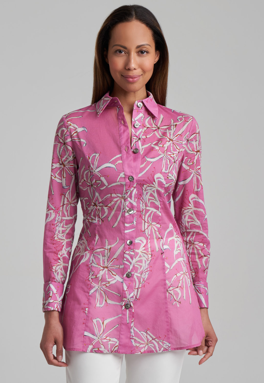 Woman wearing cotton shirt blouse in pink watermelon spider lily print by Ala von Auersperg for spring summer 2021