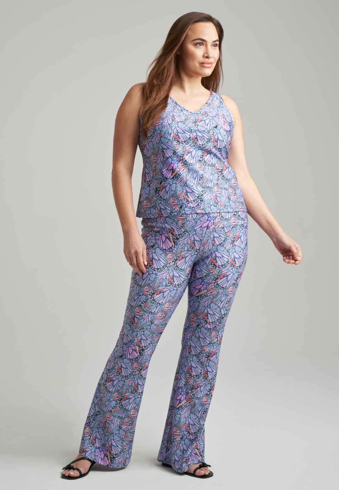 Woman wearing butterfly printed stretch knit purple pants with butterfly printed purple stretch knit tank top by Ala von Auersperg for spring summer 2021