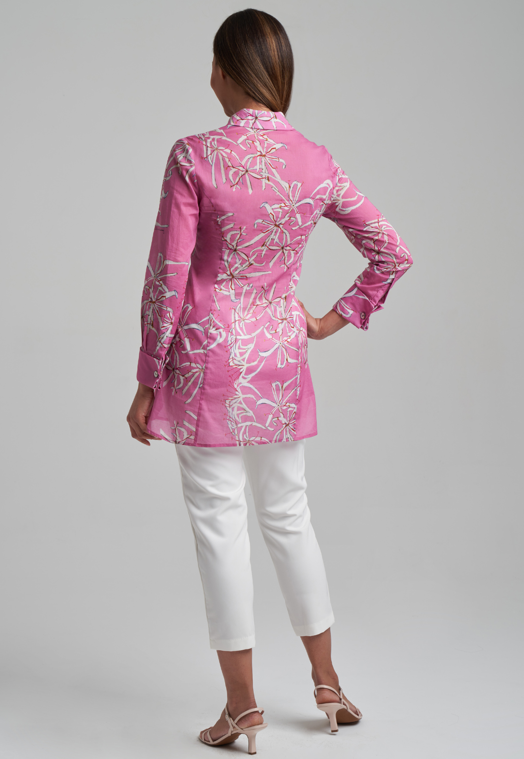 Woman wearing cotton shirt blouse in pink watermelon spider lily print by Ala von Auersperg for spring summer 2021