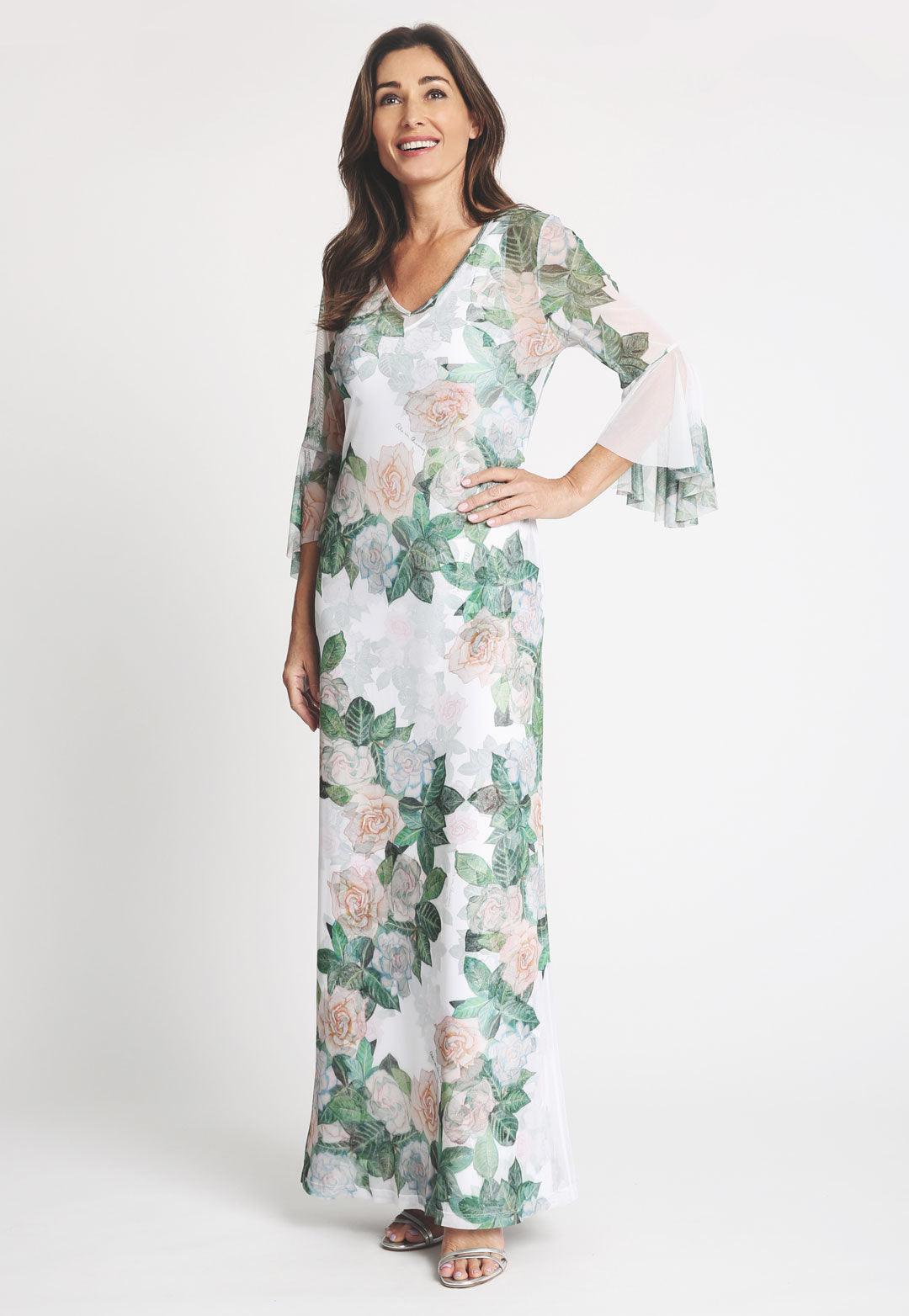 Model wearing mesh long three quartered sleeve gardenia flower printed dress over a long gardenia flower printed stretch knit dress
